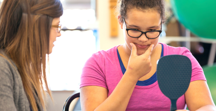 female_speech_therapist_helping_young_female