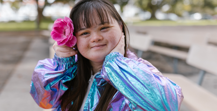 Girl_smiling_wearing_a_flower