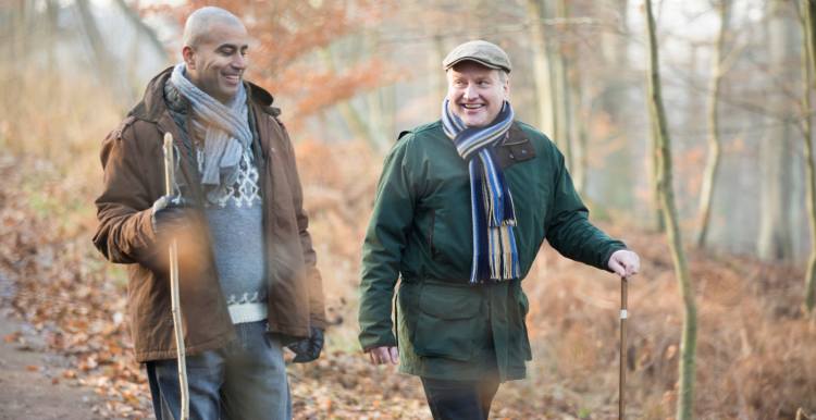 two_men_wrapped_up_warm_going_for_a_winter_walk_in_the_woods