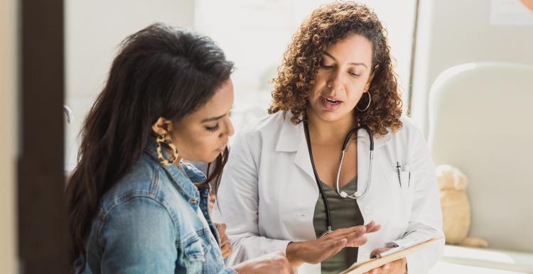 woman_doctor_discussing_information_with_a_dark_haired_young_woman