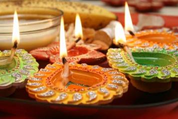 green and orange candle holders with lit candles