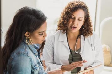 woman_doctor_discussing_information_with_a_dark_haired_young_woman