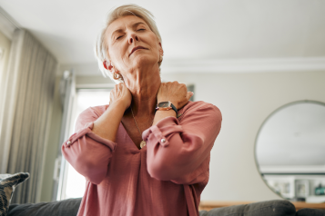 Woman_with_short_white_hair_stretching_her_neck