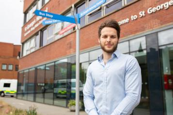 A man standing outside a hospital